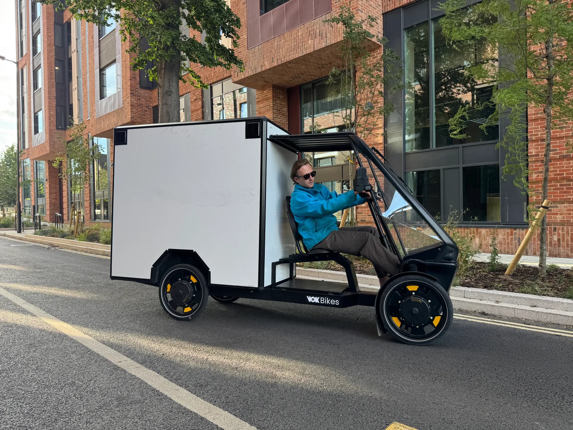 Tyred COO Nikita Baranov in a VOK cargo bike on a London street.