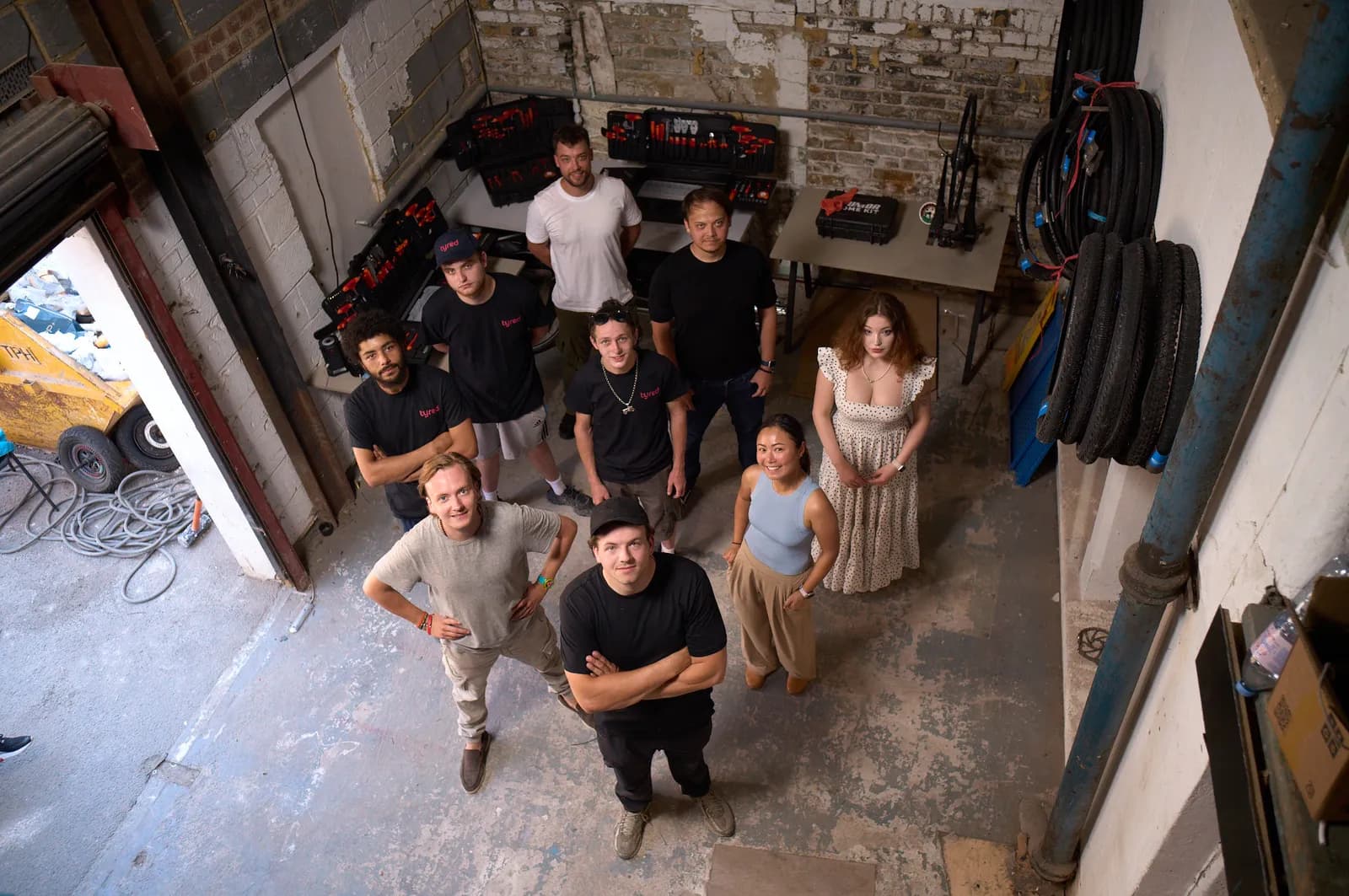 The Tyred team together in their London workshop, surrounded by tools and spare tyres.